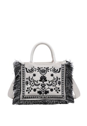 Weiße Stoffhandtasche mit schwarzer Blumenstickerei und schwarzem Fransenbesatz, mit doppelten Griffen und abnehmbarem Schulterriemen.