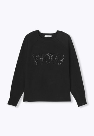 Sweatshirt noir avec des manches raglan arborant un design en sequins scintillants "WOW" sur le devant. Tissu doux et poignets côtelés.