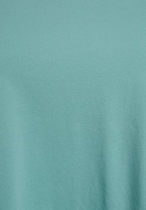 Tissu uni de couleur sarcelle avec une texture tissée subtile en horizontale et verticale et de légères ombres de plis.