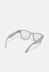 Gray translucent rectangular eyeglasses with clear lenses and thick frames laid open facing upward on a white surface.
