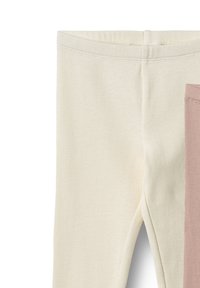 Nærbillede af linning på ribstrikkede leggings i off-white og dæmpede lyserøde farver.