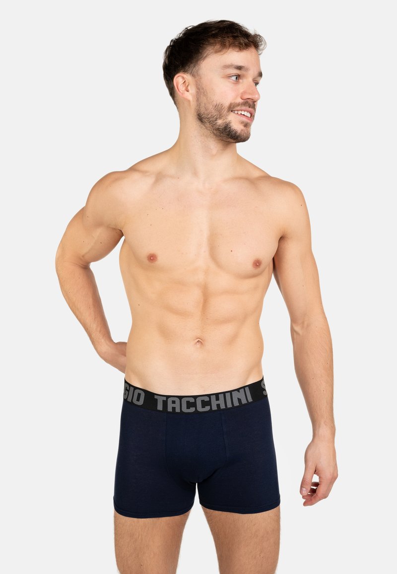 Navy cotton boxer briefs with a black waistband featuring "Sergio Tacchini" in grey lettering. Fitted design with a smooth texture.