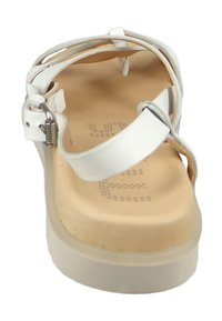 White leather sandal with multiple straps, a flat sole, and a slightly raised heel. Features a buckle fastening and a textured insole.