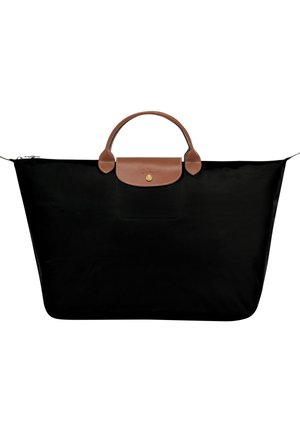 Black tote bag made of nylon with a textured brown leather handle and flap. Features a zip closure and a gold emblem on the front.