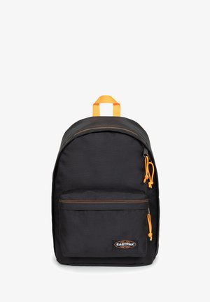 Black backpack with orange accents, top handle, front zip pocket, and drawstring closure. Made of durable material with visible stitching details.
