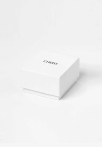 White square jewelry box with a smooth surface, featuring a black "CHRIST" logo on the top and a matching base. Minimalist design.