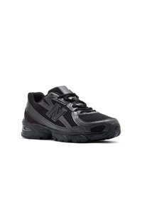 Black running shoe with a mesh upper, padded collar, and rubber sole. Features a prominent logo and textured accents.