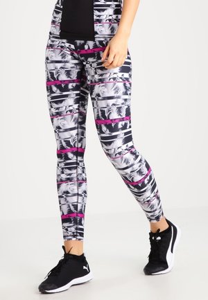 Des leggings à motifs noir et blanc dotés de rayures horizontales roses et d'une taille haute. Confectionnés en tissu extensible, ils conviennent parfaitement aux activités sportives.
