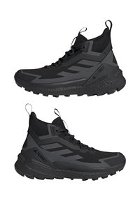 Schwarze Wanderschuhe mit hohem Schaftdesign, ausgestattet mit Mesh- und synthetischen Materialien, strukturiertem Außenrand und verstärkter Zehenkappe.