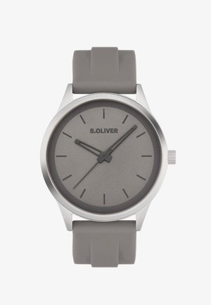 Grey silicone strap watch with a round silver case, minimalist grey dial, black hour markers, and a brand logo at the 12 o'clock position.