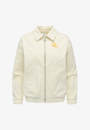 Roomkleurig jack met ritssluiting en kraag, twee zijzakken, elastische manchetten en een kleine gele zon- en golfborduursel op de linkerborst.