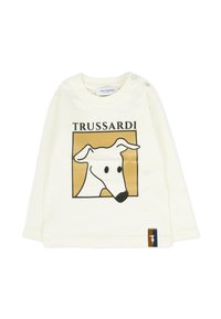 T-shirt a maniche lunghe crema con grafica di un cane nera e dorata, caratterizzato da un collo rotondo e dettagli con bottoni sulla spalla.