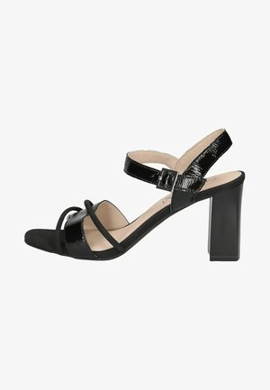 Sandales noires à talons, avec des accents en cuir verni et en daim, un design à bout ouvert, et un talon épais pour plus de stabilité. Bride de cheville ajustable incluse.
