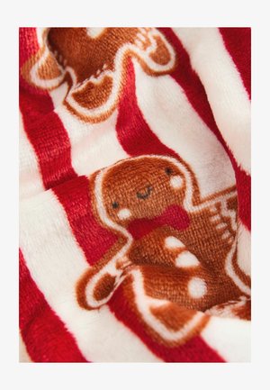 Piros és fehér csíkos fleece anyag, barnás mézeskalács ember mintával, masnival és fehér részletekkel. Puha tapintású.