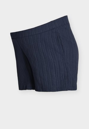 Shorts en tissu texturé bleu marine avec une ceinture élastique et des poches latérales sur fond blanc.
