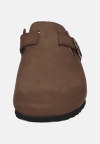 Brown leather clogs with a rounded toe, a side buckle strap, and a textured surface. Flat rubber sole with slight edge detailing.