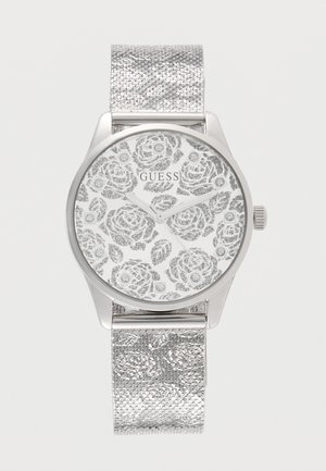 Orologio da polso Silver Guess con motivo floreale sul quadrante e cinturino a maglie, design minimalista, senza numeri, lancette di ore e minuti visibili.