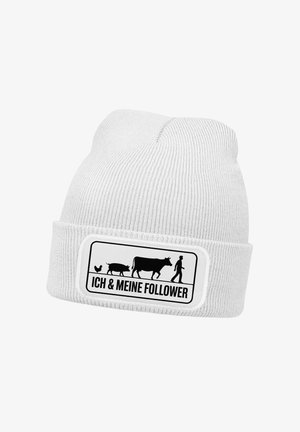 White beanie hat with vertical ribbing, featuring a black patch with farm animal graphics and "ICH & MEINE FOLLOWS" text.