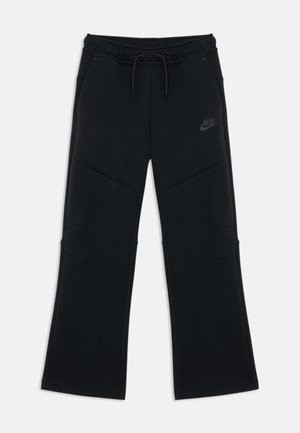Pantaloni sportivi neri con vita elastica e coulisse. Presentano un design cucito, due tasche laterali e un piccolo logo Nike nero sull'anca.