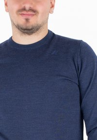 Camicia a maniche lunghe blu navy con collo a giro, texture a coste e un piccolo logo tono su tono nella parte superiore sinistra del petto.