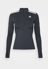 Maglietta sportiva Adidas nera a maniche lunghe con strisce bianche sulle spalle, colletto con zip e aperture per i pollici sulle maniche.