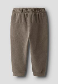 Pantalon texturé marron pour tout-petit avec taille élastique et chevilles resserrées, présenté sur un fond gris clair.