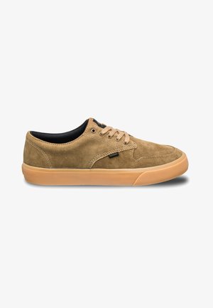 Brown suede low-top sneaker with rubber gum sole and black inner lining. Features six lace eyelets and stitched accents.