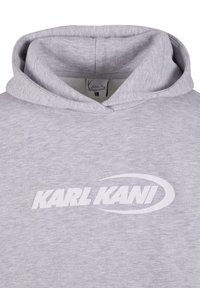 Light gray hoodie made from soft fabric, features a large white "KARL KANI" logo across the chest and a classic drawstring hood.