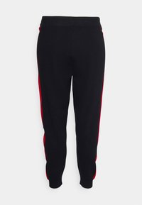 Schwarze Jogginghosen mit rotem Seitestreifen, weichem Stoff, elastischem Bund und engen Bündchen an den Knöcheln. Einfaches Design, lässiger Stil.