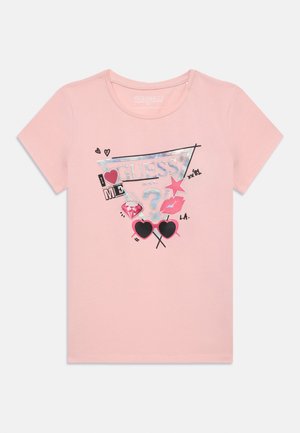 Pink cotton t-shirt featuring a graphic design with a mix of black and holographic elements, hearts, sunglasses, and text. Short sleeves.