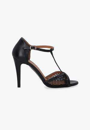 Black high-heeled sandals with a T-strap design, featuring a smooth leather upper and mesh detailing on the sides. Open toe and heel.