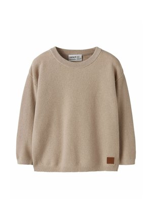 Pull en maille beige à manches longues avec col rond et petite pièce rectangulaire marron près de l'ourlet, conçu pour les enfants.