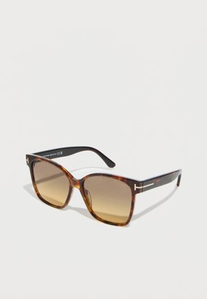 Tortoiseshell square sunglasses with gradient brown lenses and gold T-shaped logo accents on the temples.