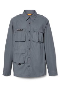 Szara koszula z długim rękawem wykonana z lekkiego materiału. Posiada cztery przednie kieszenie, zatrzaski oraz kołnierz z pomarańczowym akcentem wewnątrz.