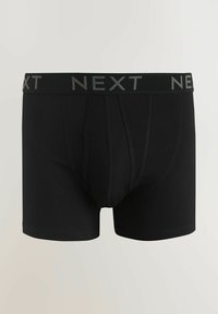 Boxeri negri dintr-un material elastic, cu o talie lată elastică pe care scrie "NEXT" în gri. Design clasic cu un croi strâns pe corp.