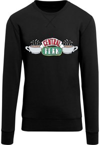 Čierna mikina s logom "Central Perk" obsahujúcim dva šálky kávy a paru, vytlačená v bielej, zelenej a červenej farbe. Jednoduchý, neformálny dizajn.