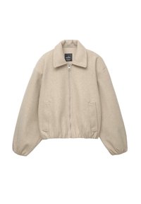 Beige kort jacka med dragkedja, bred krage och elastiska ärmslut. Tillverkad av mjukt tyg med två framfickor.