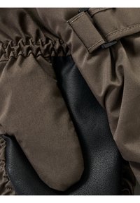 Brun tyghandske med ett texturerat svart läderhandflata. Har samlat tyg vid handleden och en detalj med plastspänne.