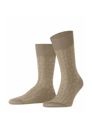 Beige Socken mit einem strukturierten Muster, gerippten Bündchen und glatter Textur. Das Design zeigt geometrische Formen über den gesamten Stoff.