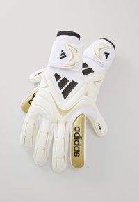 White goalkeeper gloves with black and gold accents. Features padded palms, adjustable wrist straps, and distinct brand markings.