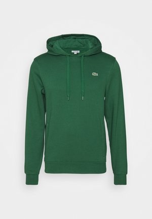 Ciemnozielona bluza z kapturem ze ściągaczami, kieszenią kangurką i małym logo krokodyla na lewej piersi.