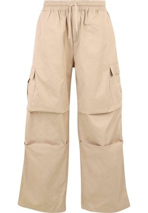 Pantalons cargo beiges avec une taille élastique, cordon de serrage ajustable et grandes poches latérales pour le rangement. Fabriqués en un mélange de coton léger.