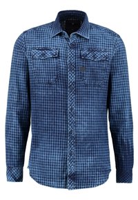 Blå rutig långärmad skjorta med två bröstfickor, knappad krage och textil med struktur. Har ett gradientmönster från mörkblå till ljusblå.