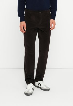 Brown corduroy trousers with a straight fit, featuring a button closure, side pockets, and smooth texture, paired with white sneakers.