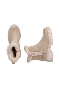 Bottines beiges avec doublure en fausse fourrure douce, extérieur en daim lisse et semelle en caoutchouc texturé. Dispose d'un design simple et d'une languette.