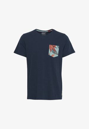 Navy blue t-shirt with short sleeves and a round neckline, featuring a turquoise pocket with a red and green tropical leaf pattern.