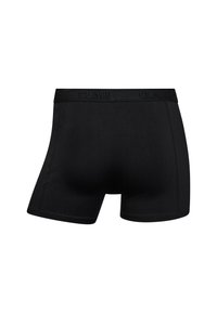 Sorte bomuldsboxershorts med en blød elastisk talje, der har præget branding. Glat tekstur og kort ben-design med syede sømme.