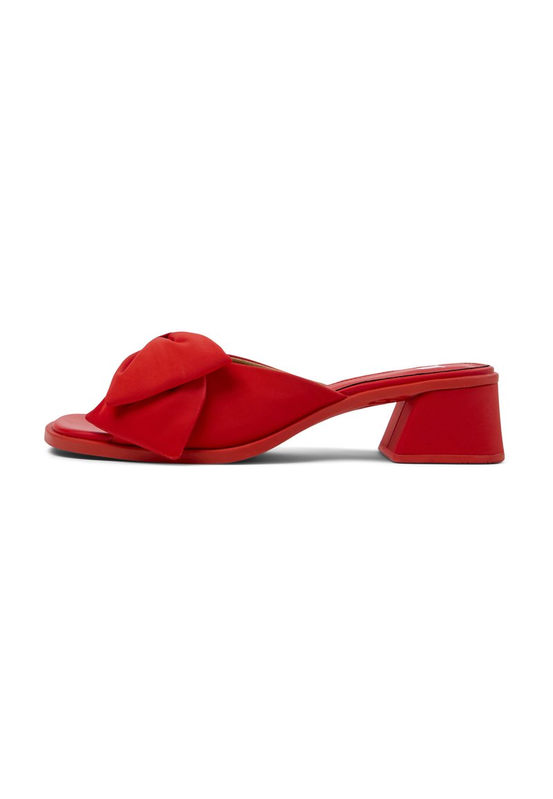 Red heeled mule with a knotted bow accent, smooth synthetic material, open toe design, and a squared block heel.