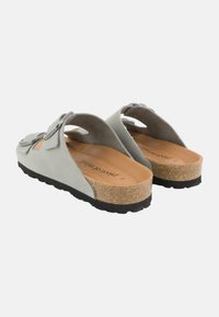 Gray suede slide sandals with an open design, cork footbed, and black rubber sole. Features a decorative silver buckle and accent stitching.