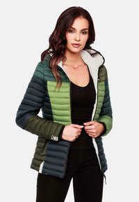 Padded jacket featuring an ombre design in dark green and light green tones with a contrasting white hood and zipper. Soft texture and structured fit.